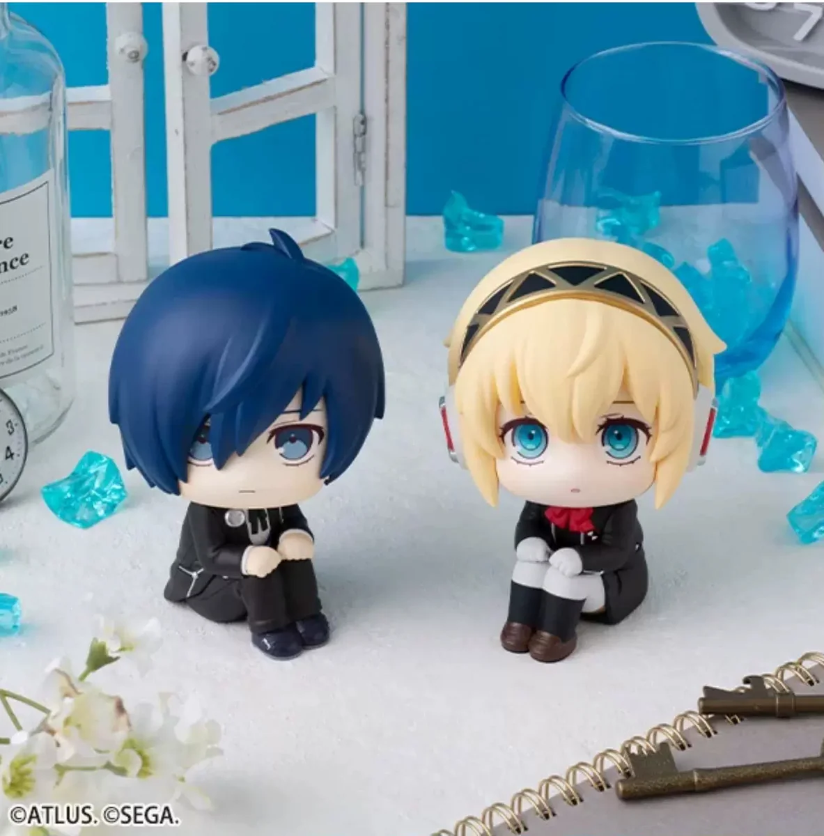 Cute MegaHouse LOOKUP Makoto Yuki and Aigis chibi figures from Persona 3 Reload. These charming collectible figures feature their iconic sitting pose.
