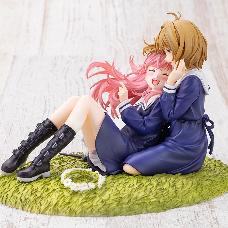 Kotobukiya Shina Mimi figure shows two schoolgirls in navy uniforms sharing a tender embrace beside a flower crown on a daisy-strewn grassy base.