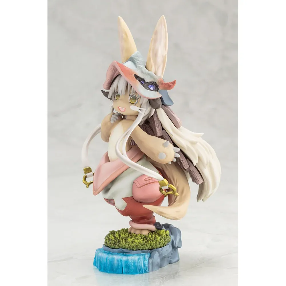 This side view of the Nanachi figure by Kotobukiya highlights sculpted pastel fur, layered hat, and mossy waterfall diorama base.